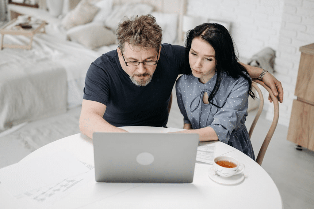 A Man and a Woman using a Laptop Together