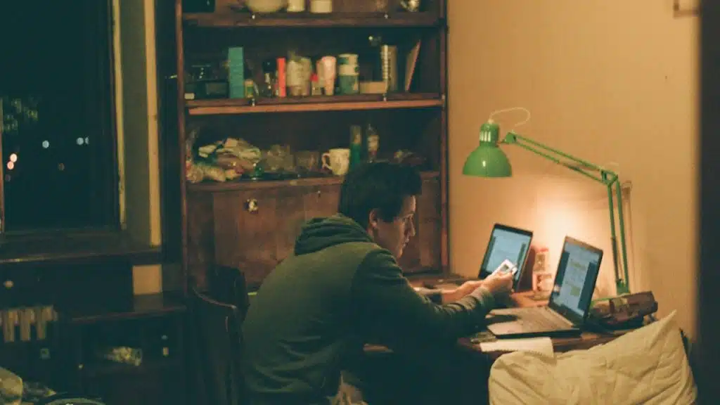 A man using his laptop in his living room.
