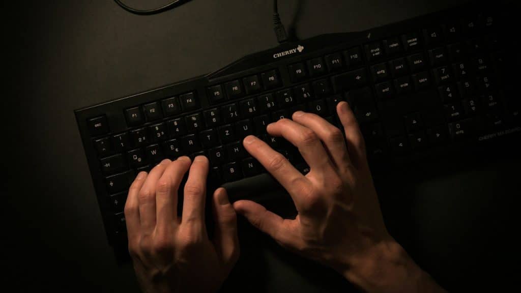 A man typing on a keyboard.