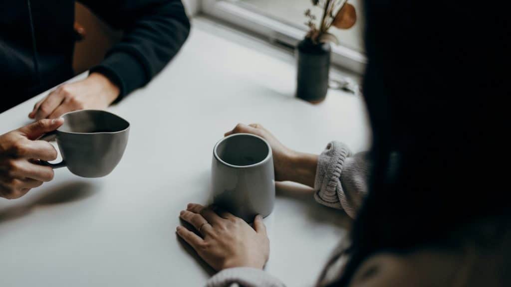 A man and a woman having coffee in a cafe.