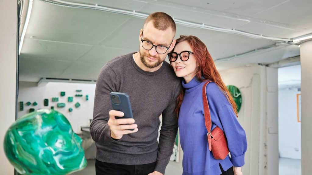 A man and a woman looking at a phone.