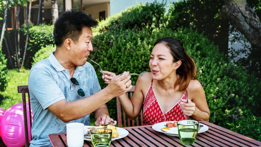 A couple eating breakfast in a hotel.
