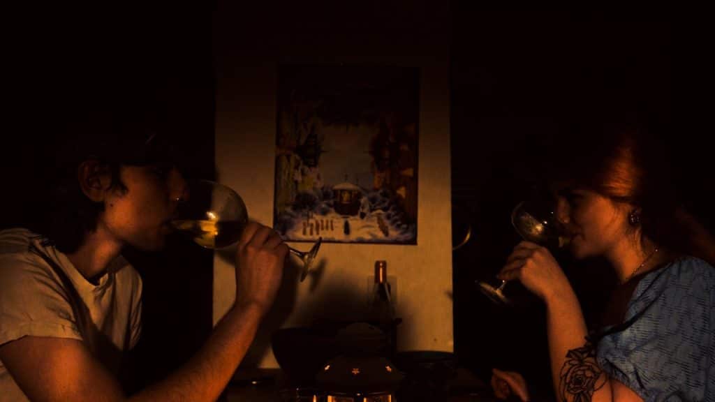 A man and a woman drinking wine in a cafe.