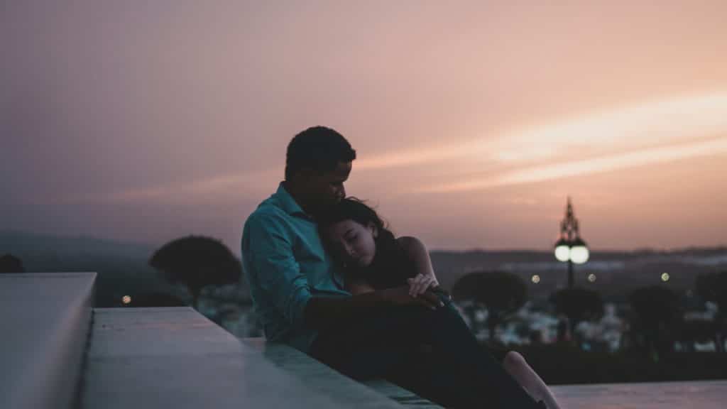 Couple on stairs during golden hour.