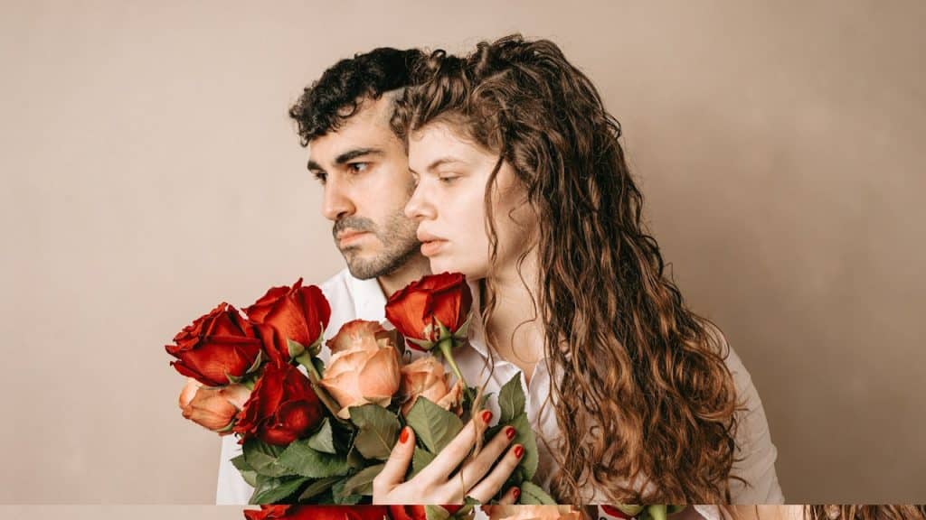 A couple holding flowers together.