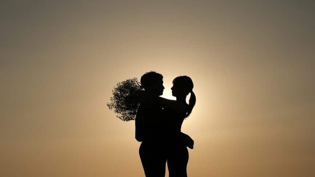 A man and woman standing with each other.