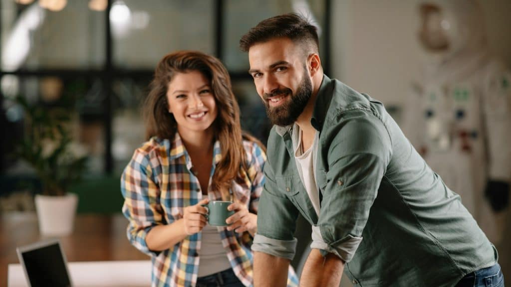 A couple working in an office together.