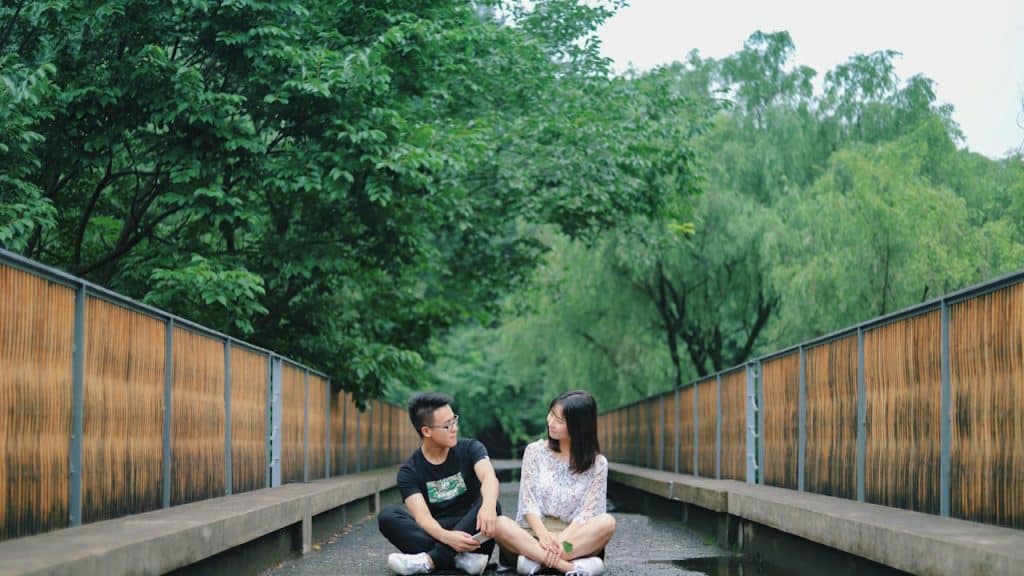 Man and woman sitting on a road.