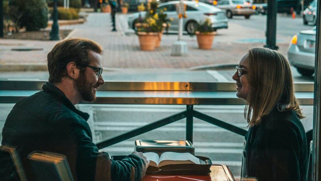 A couple talking in a cafe.
