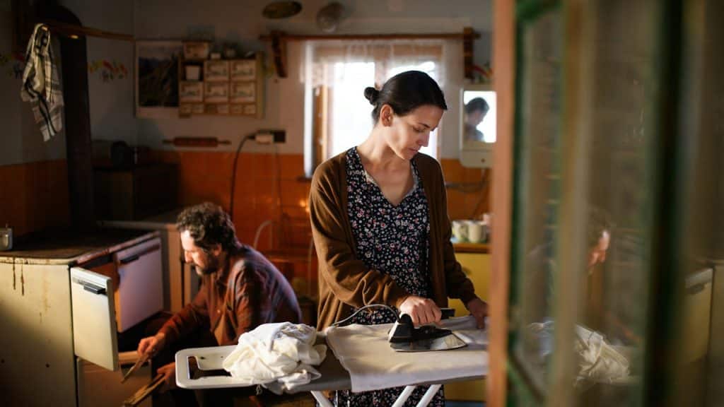 A married couple busy in doing household chores.