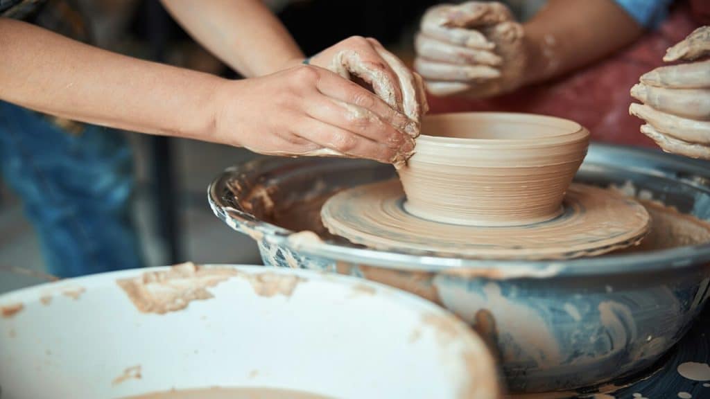 A couple taking a pottery class together