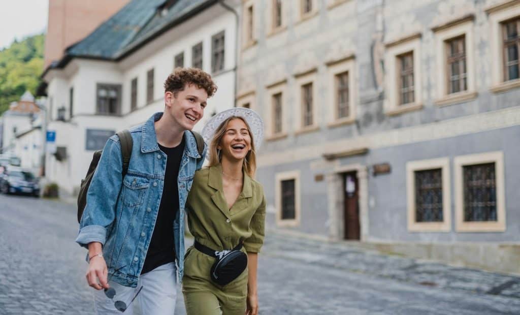 The happy  couple is walking down the street.