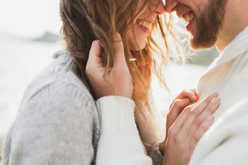 The happy couple is looking at each other.