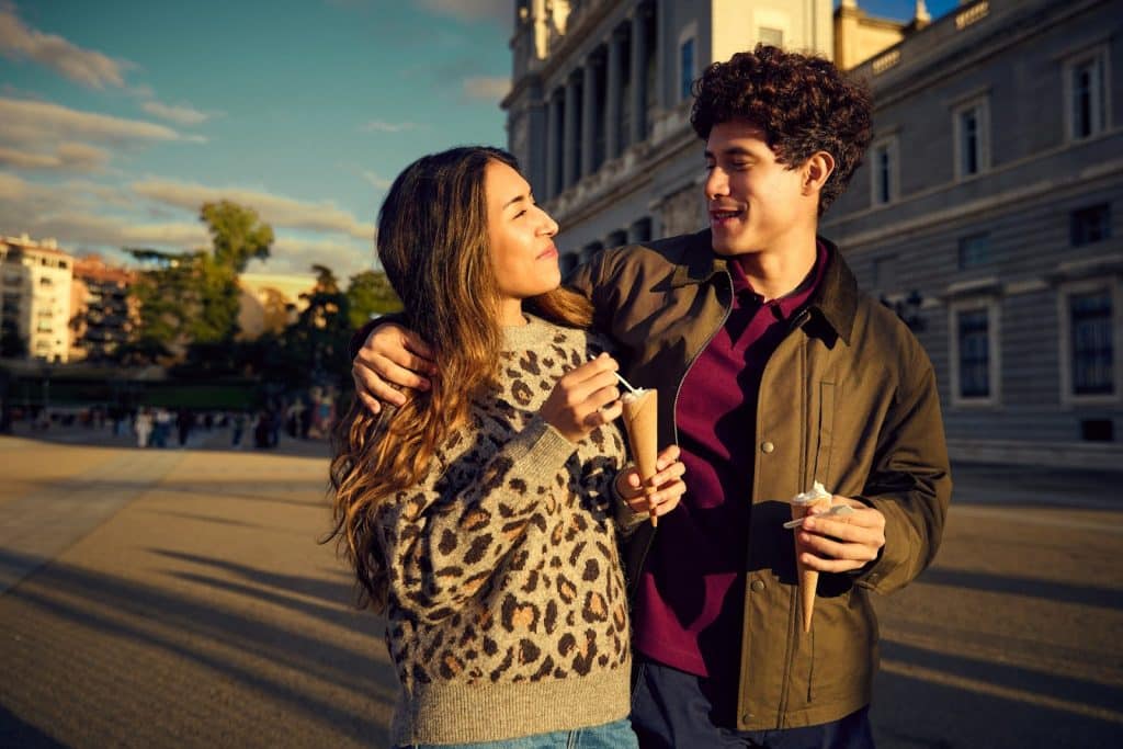 The couple is walking around the neighborhood.