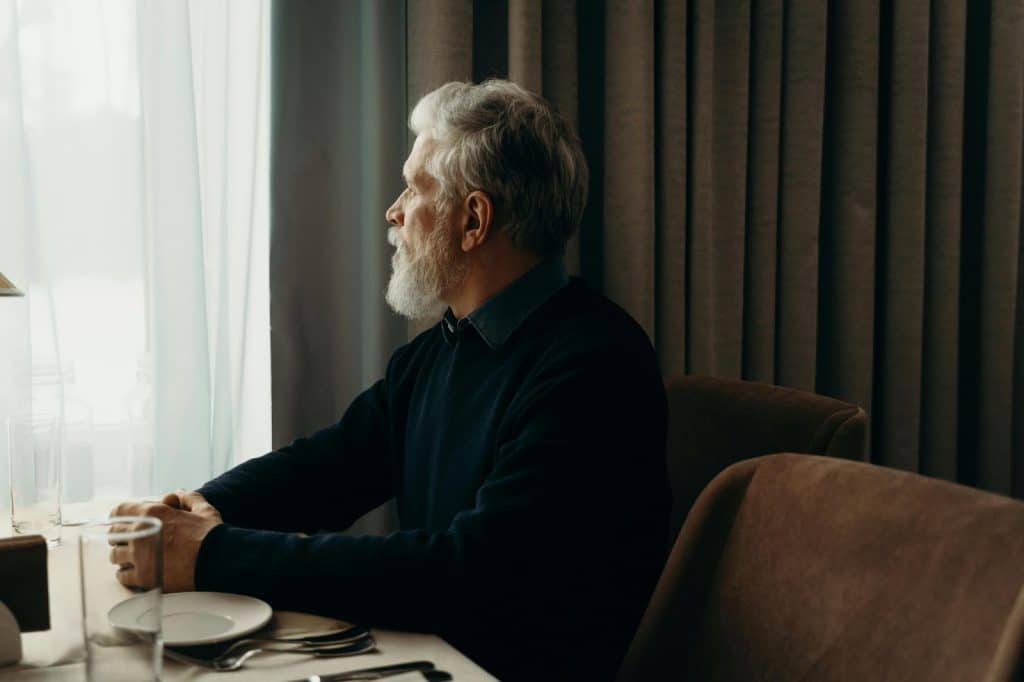 A man sitting alone and looking at the view