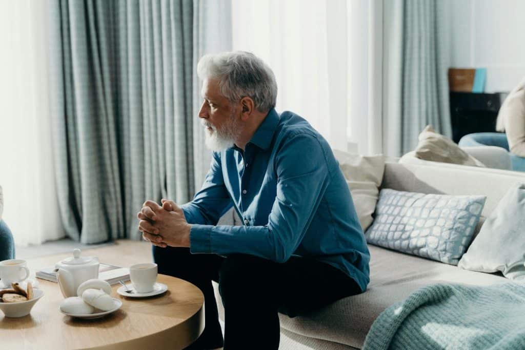 A man sitting alone in the couch