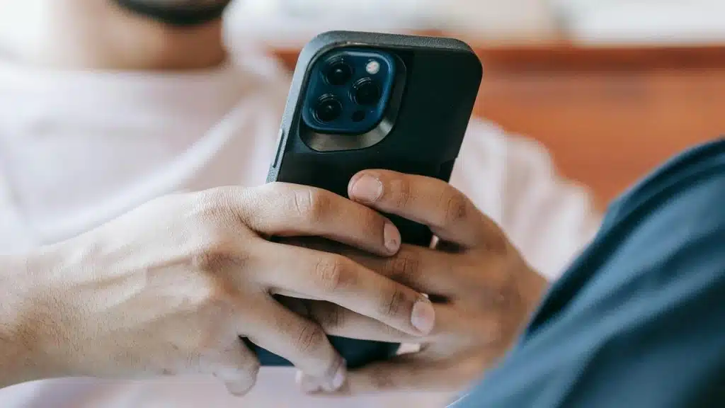 A man holding a smartphone in both hands.