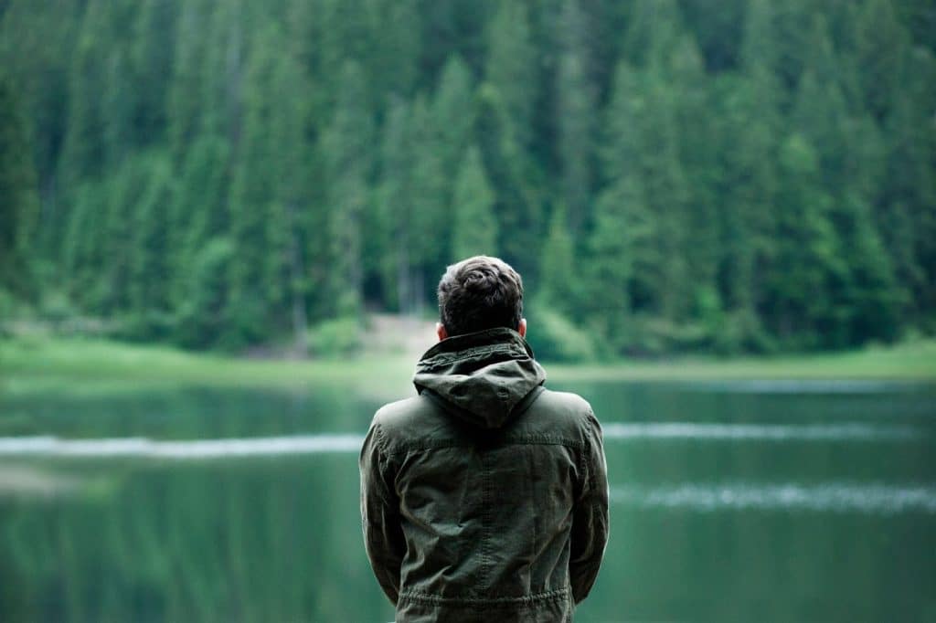 A man looking at the lake