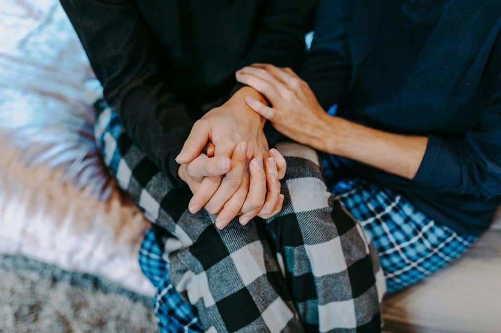 A man and woman holding hands