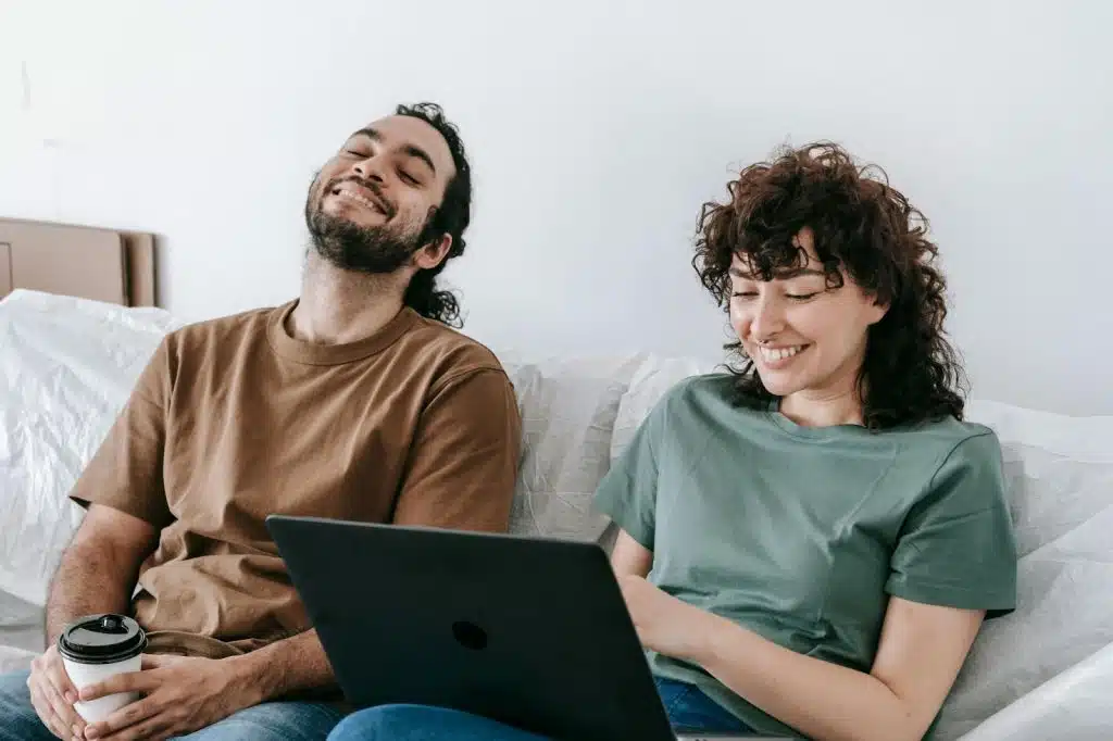 A couple sitting at the couch and having a good time