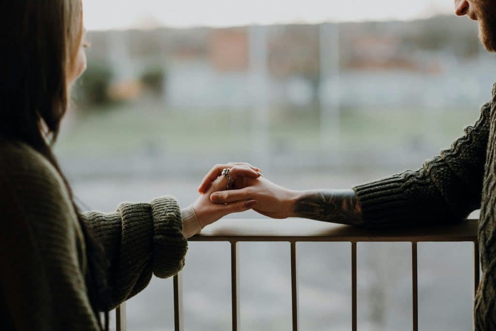 A man and woman holding hands
