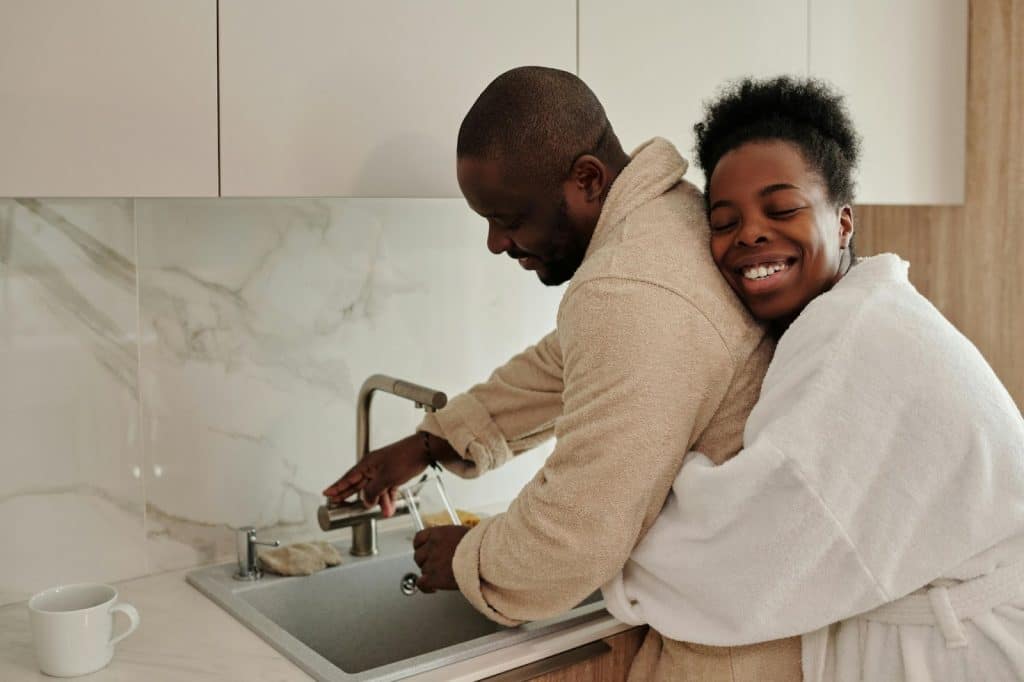 A woman hugging a man from behind