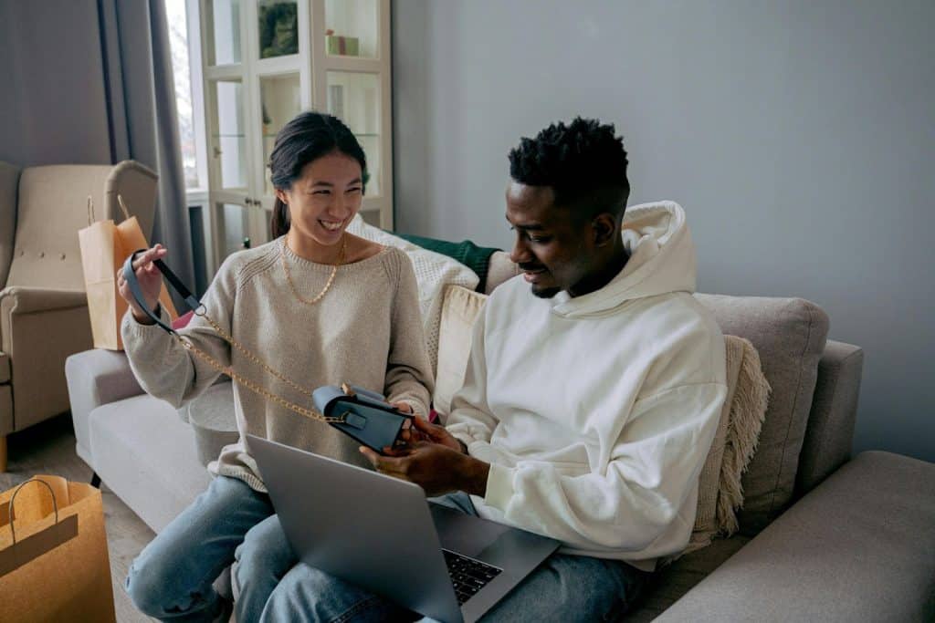 A man looking at the new bag of a woman