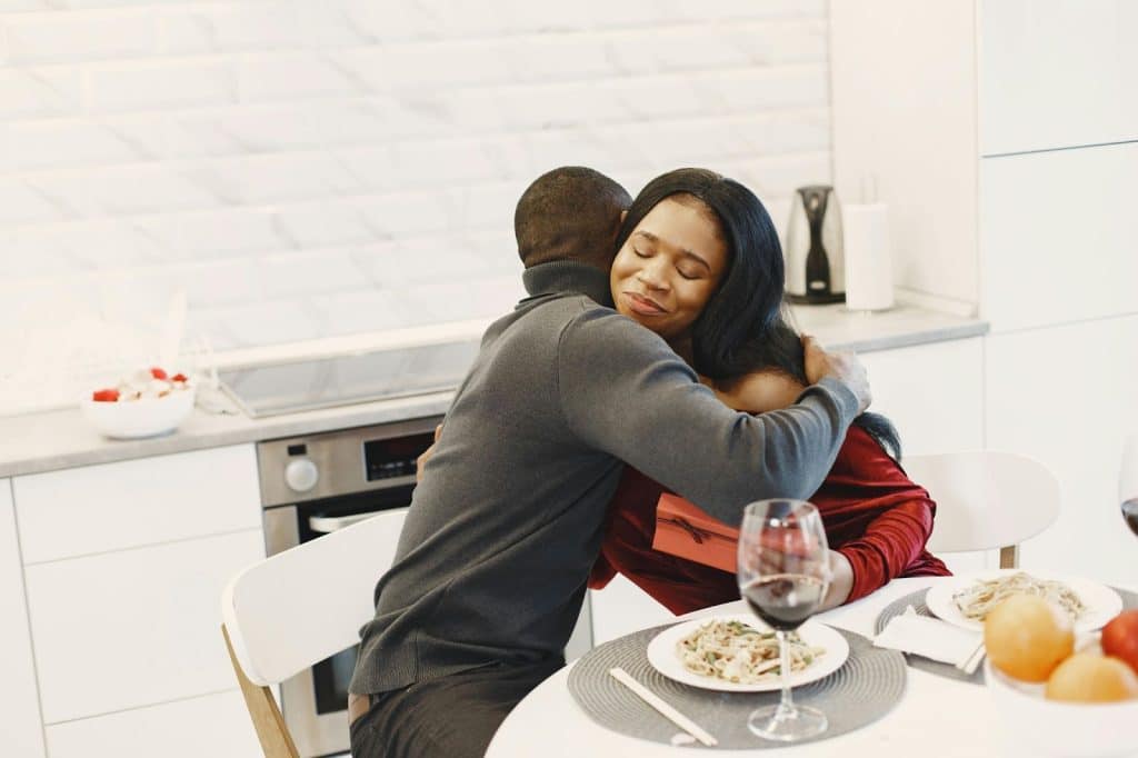 A man hugging a woman