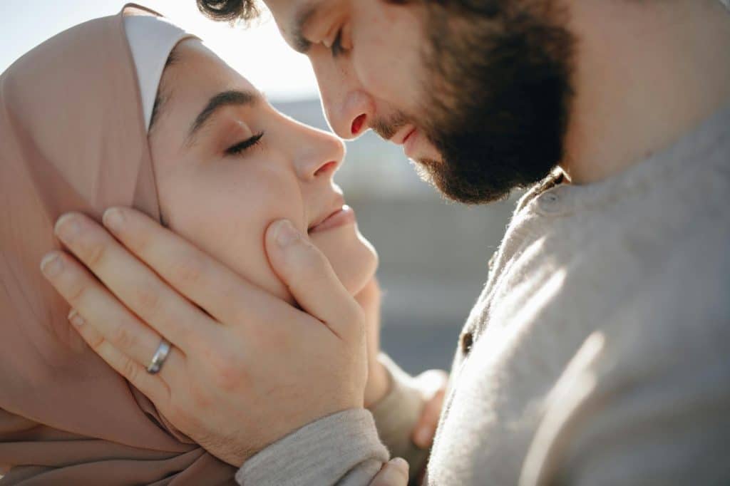 A man holding a woman’s face
