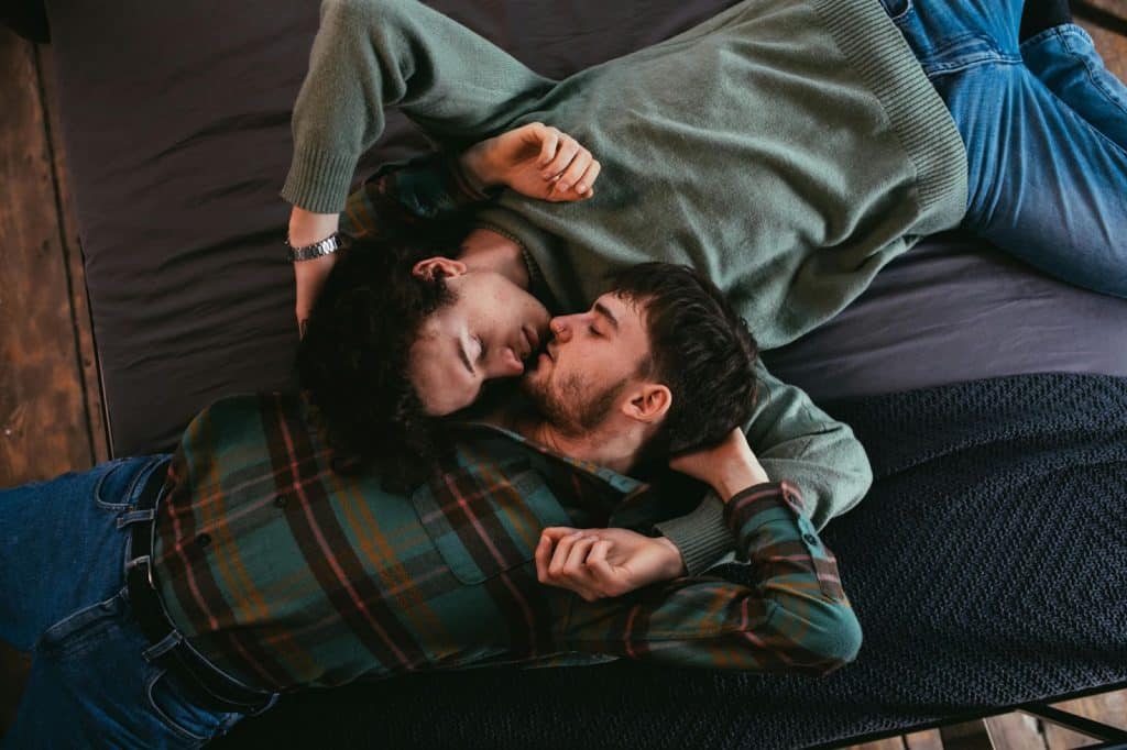 A man and woman laying in bed together