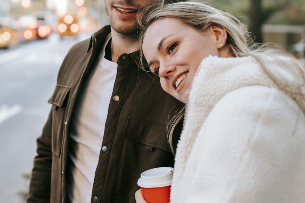 A woman leaning her head on man’s shoulder