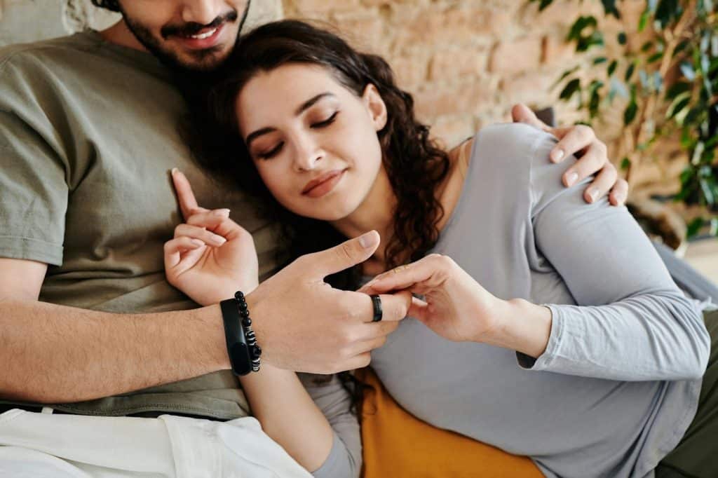 A woman resting her head on a man’s chest
