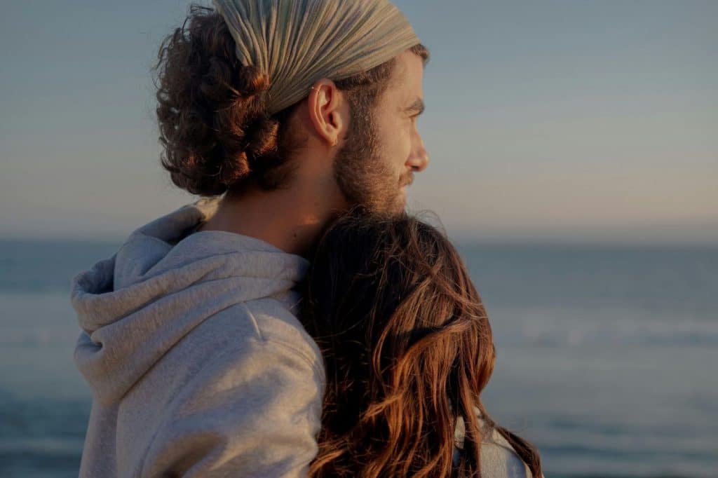 A man hugging a woman