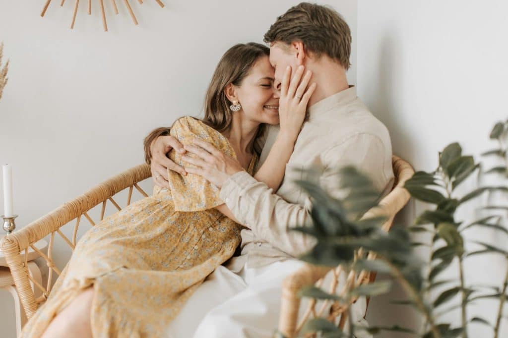 A woman kissing a man