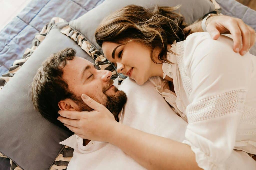 A man and woman laying in bed