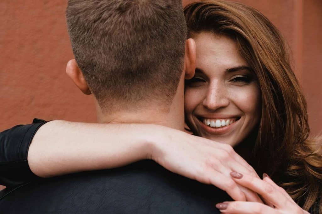 A woman hugging a man