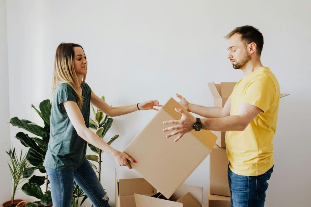 A man and woman helping each other