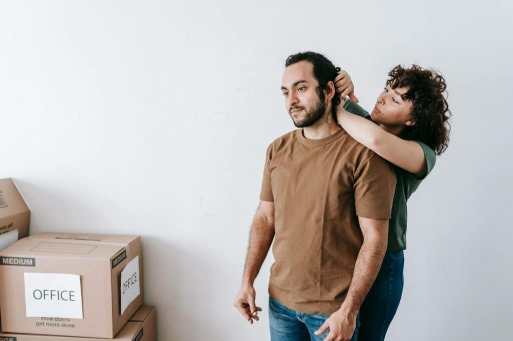 A man fixing a man’s hair
