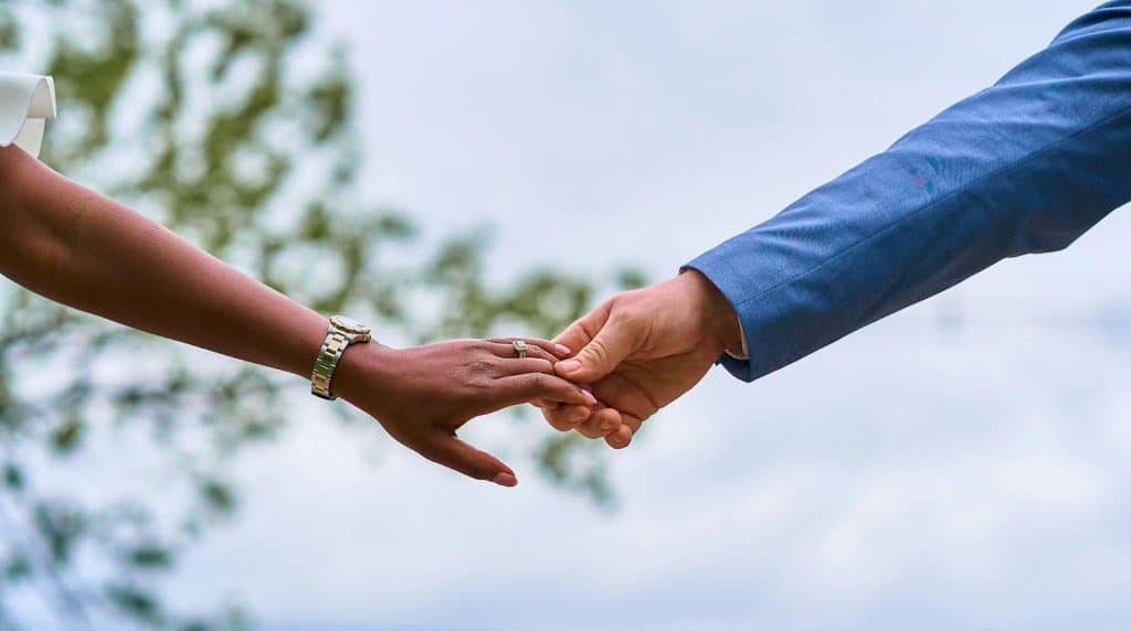 A man and woman holding hands