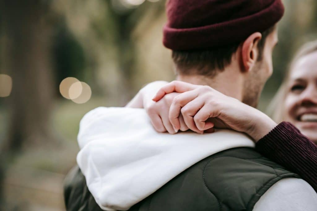 A woman hugging a man