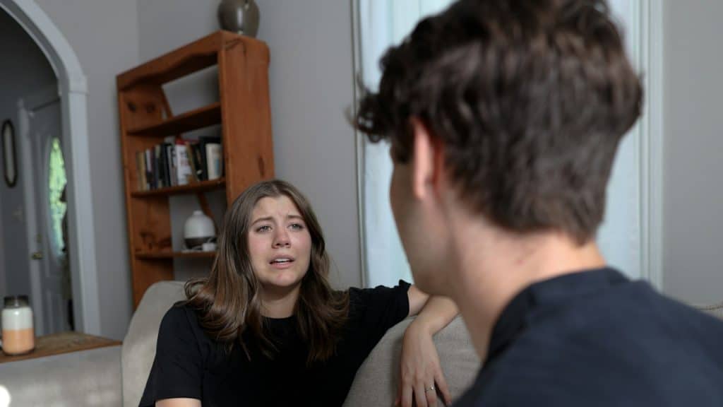 A sad woman talking to her boyfriend.