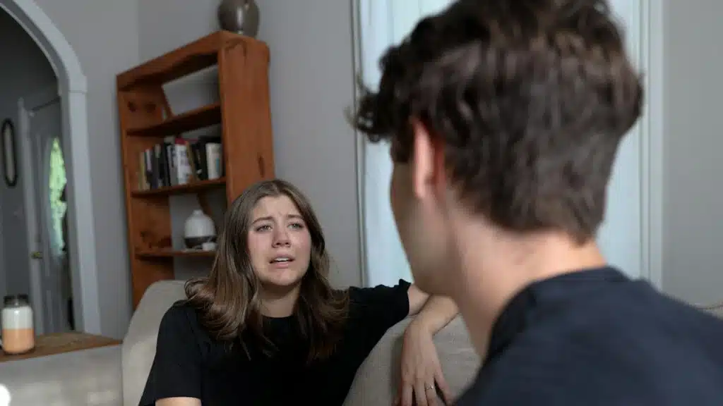 A sad woman talking to her boyfriend.