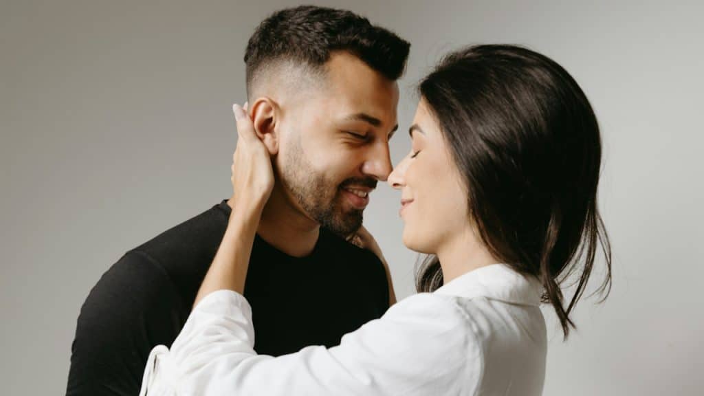 A man and woman are embracing each other.