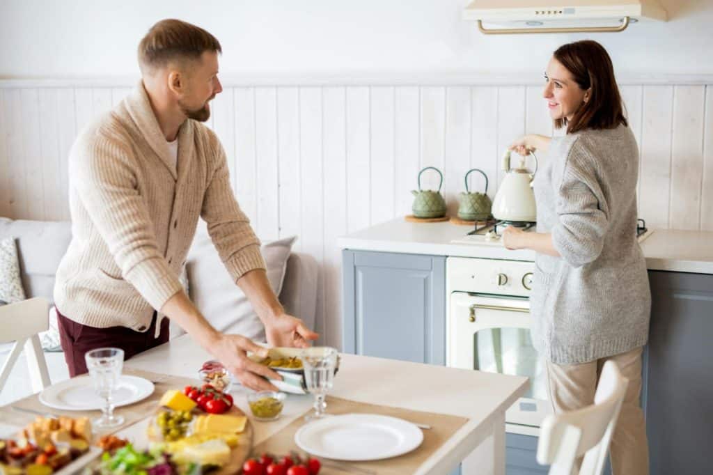 A man helping a woman to prepare a food