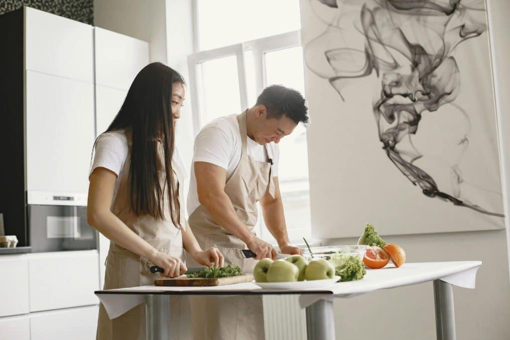A man helping a woman at the kitchen