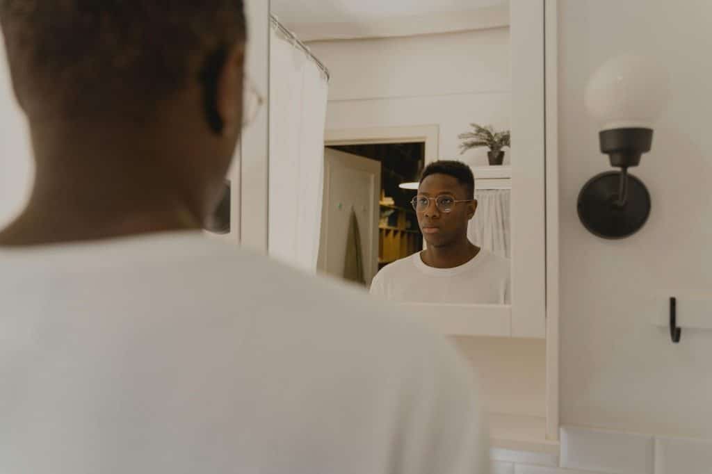 A man thinking while looking at the mirror