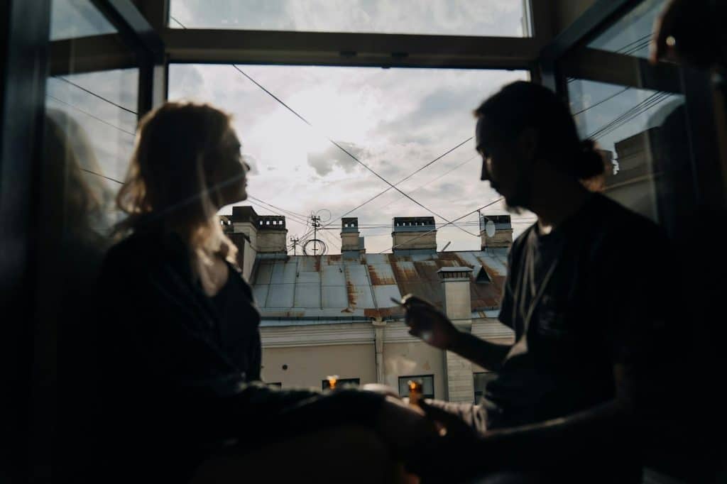 A man and woman sitting at the window