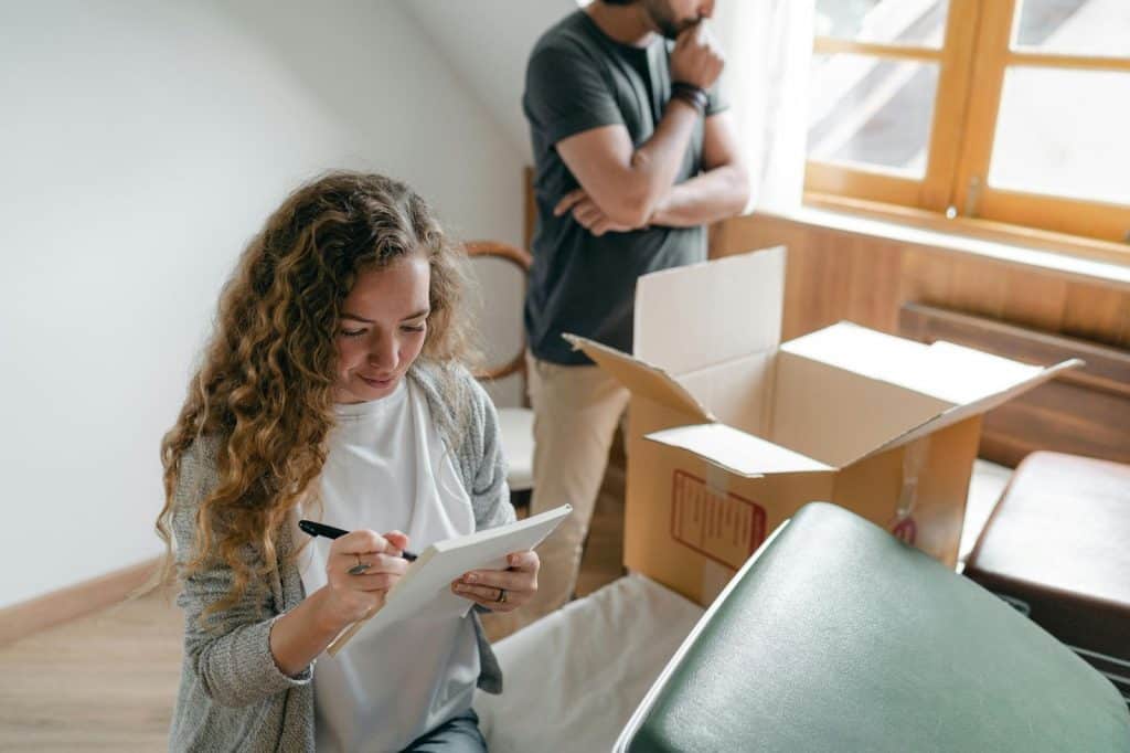 A man and woman checking their things