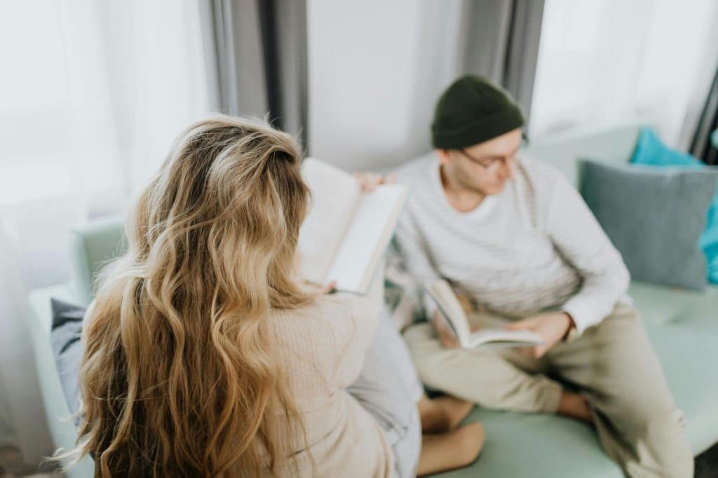 A man and woman sitting at the couch