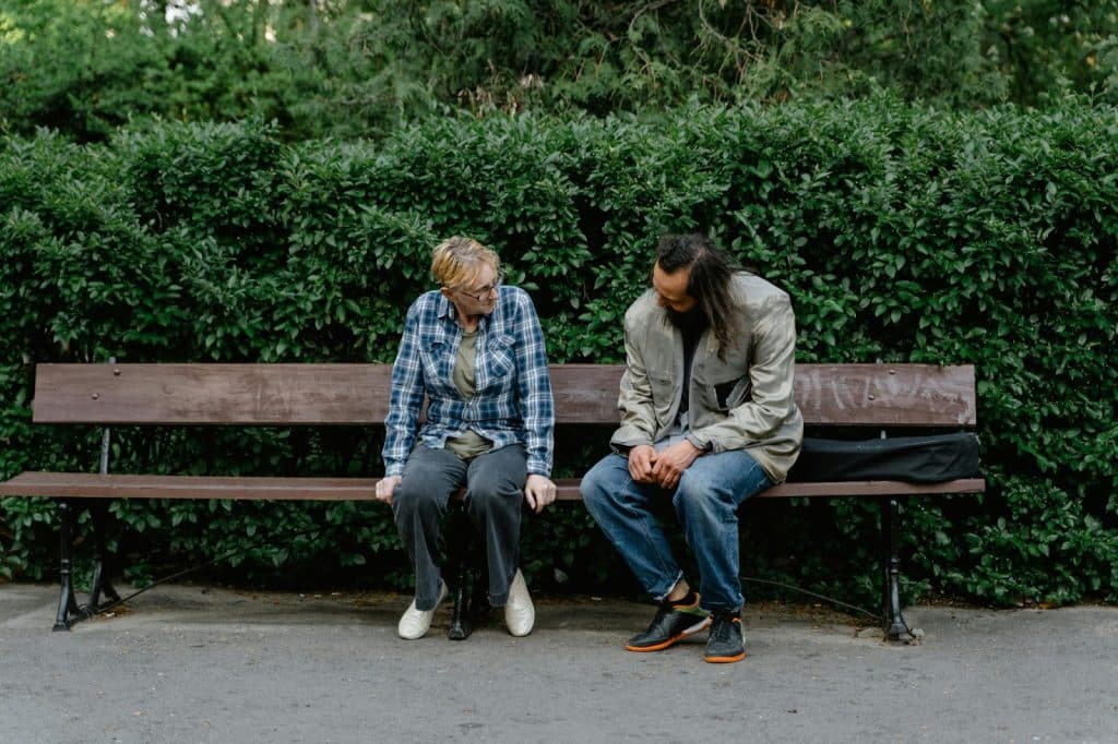A man and woman sitting at the bench